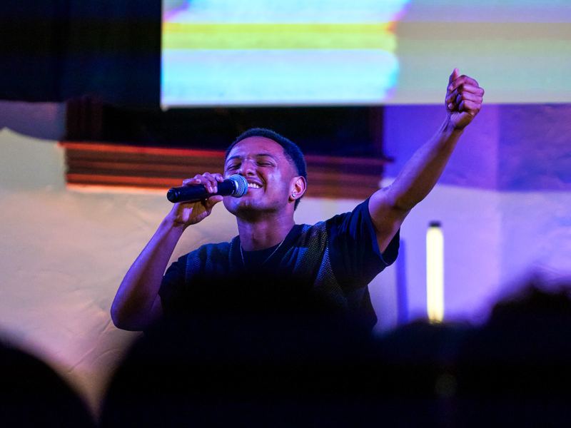 A worship leader singing on Sunday