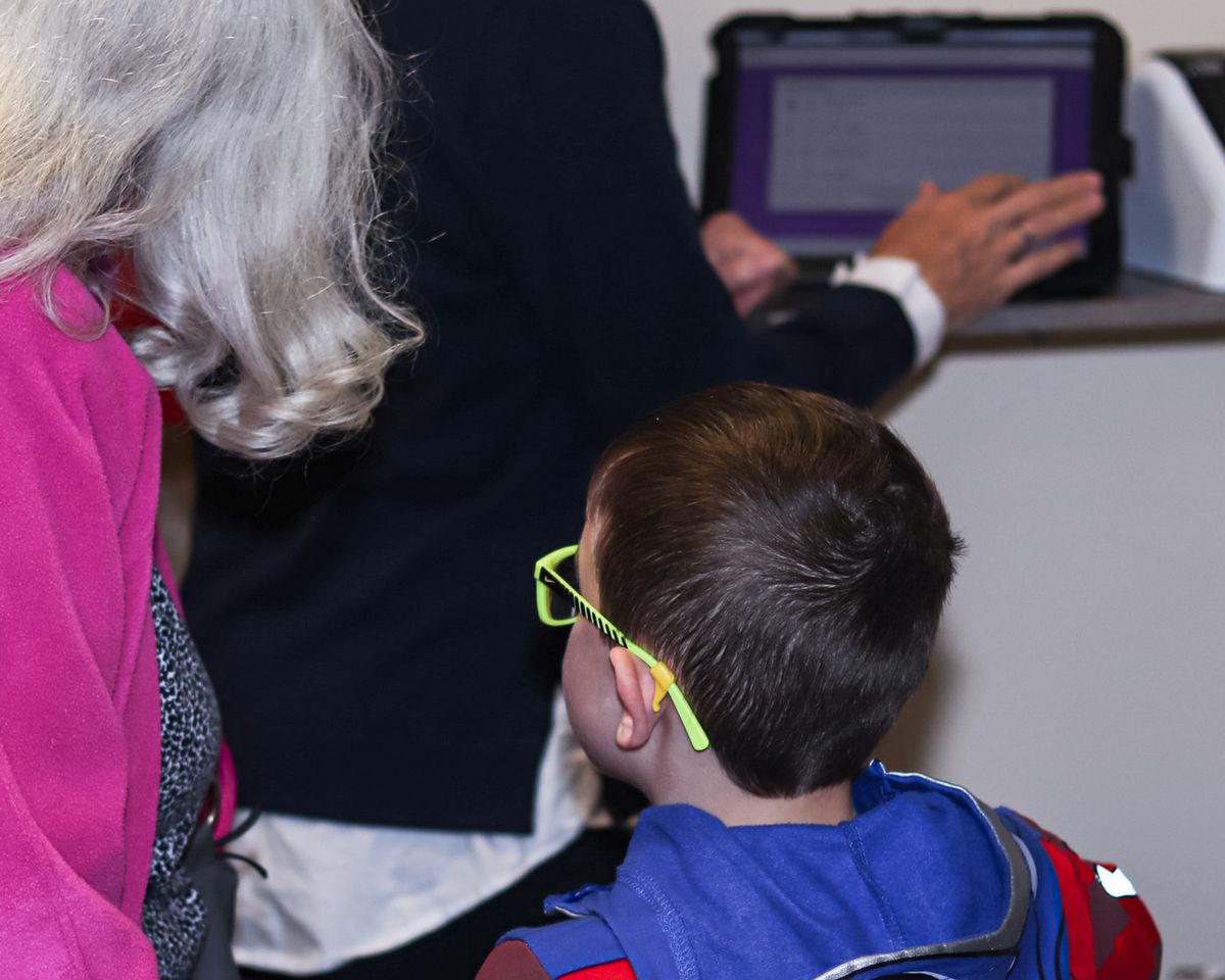 A LifeKids volunteer checking in a child